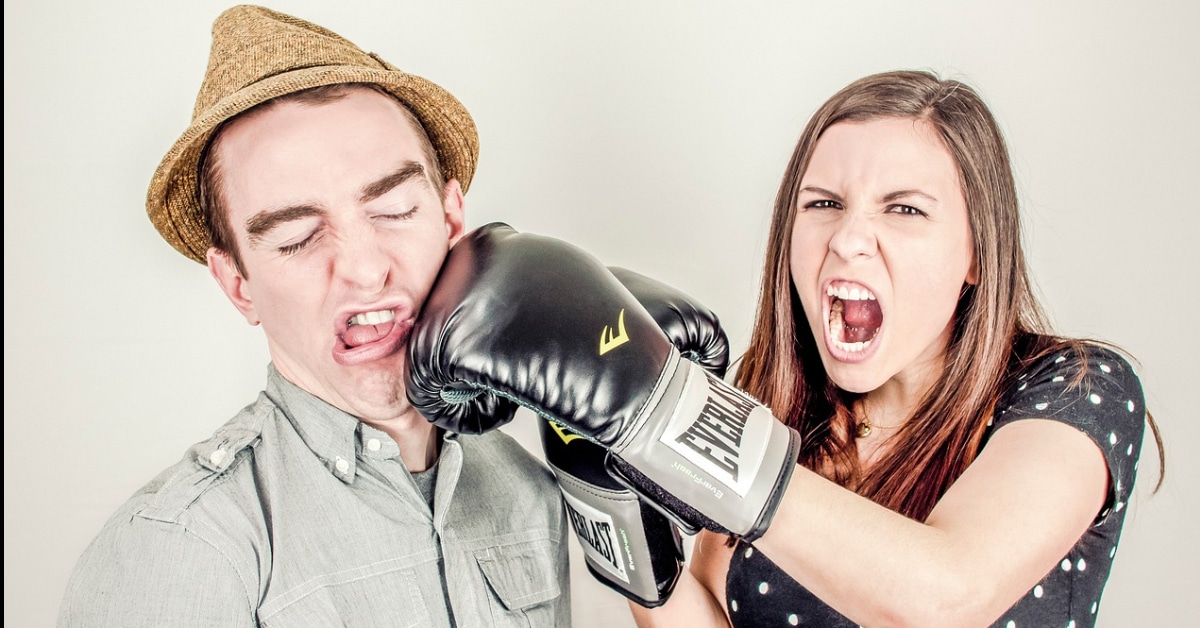 girl punching man in the face with boxing globs